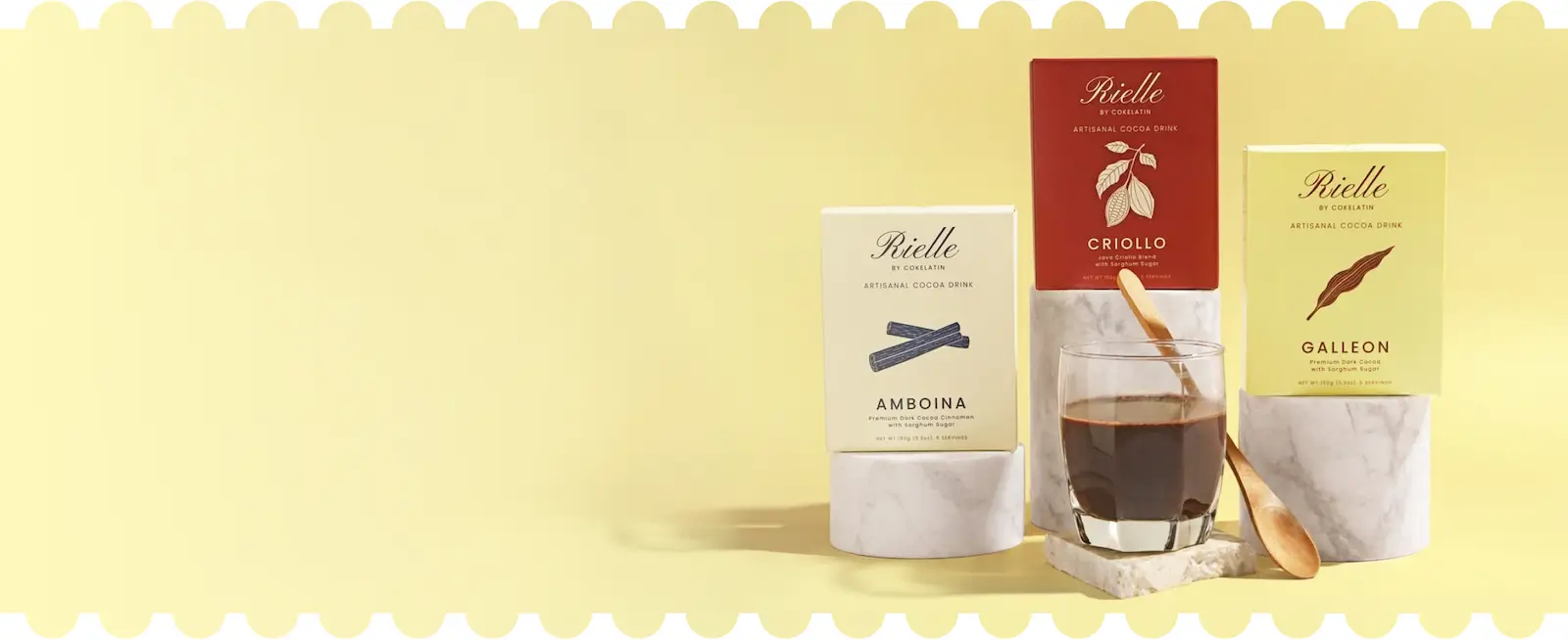 Rielle cocoa mixes displayed with a prepared cup of cocoa